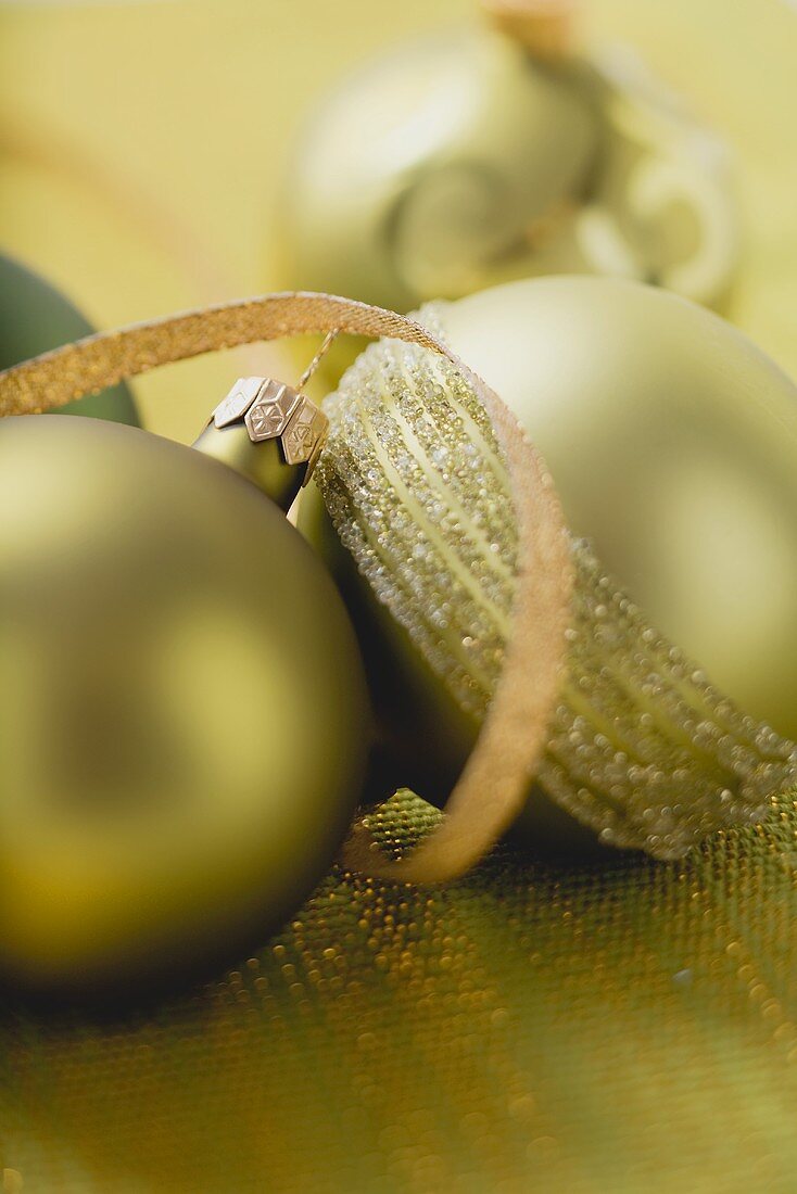 Green and gold Christmas baubles with ribbon