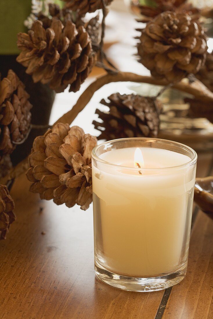 Christmas table decoration: candle and pine cones