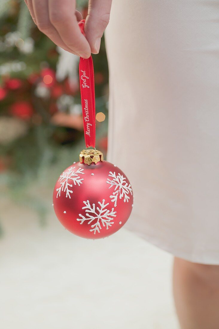 Woman holding red Christmas bauble