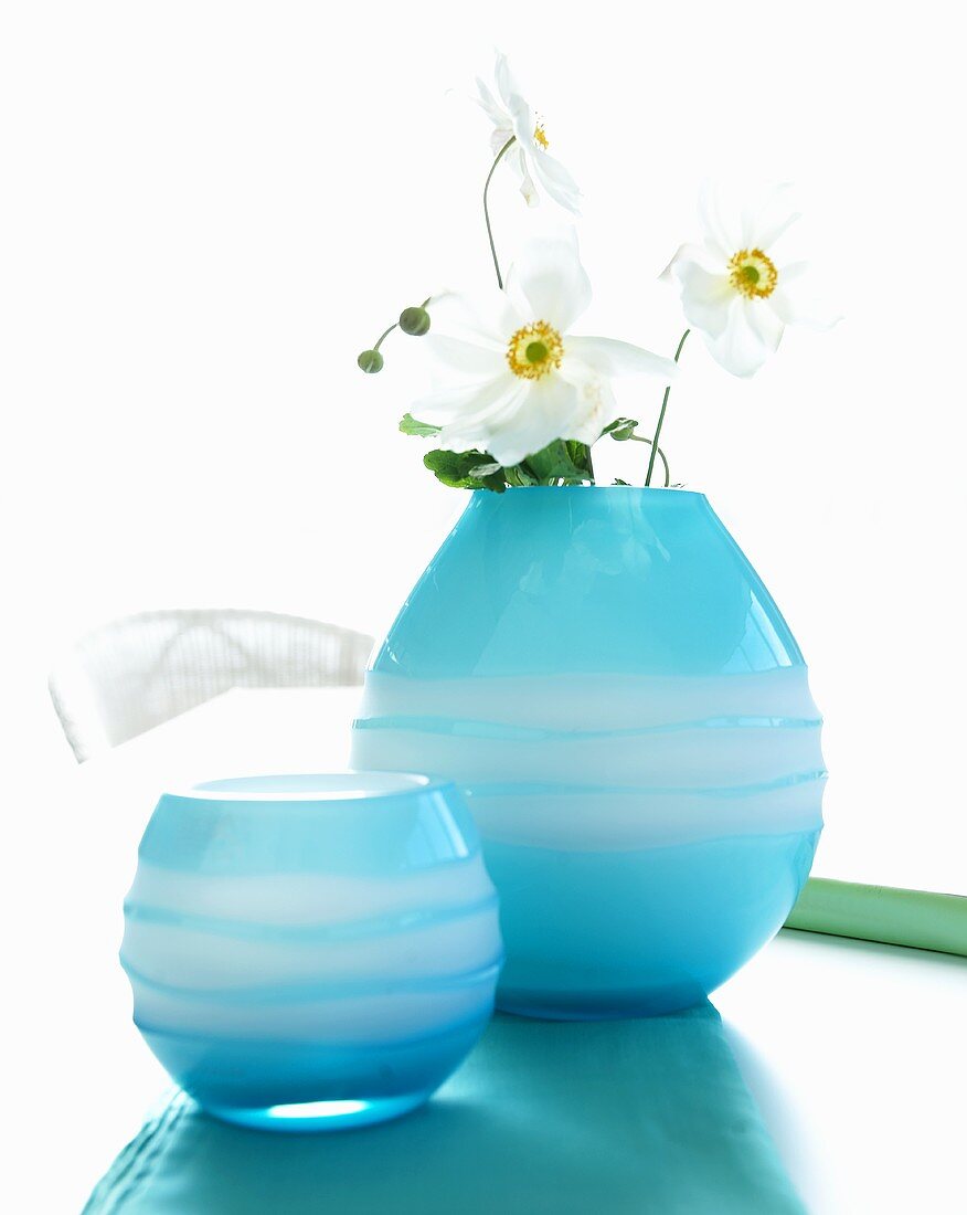 Blue glass vases one with white Japanese anemones