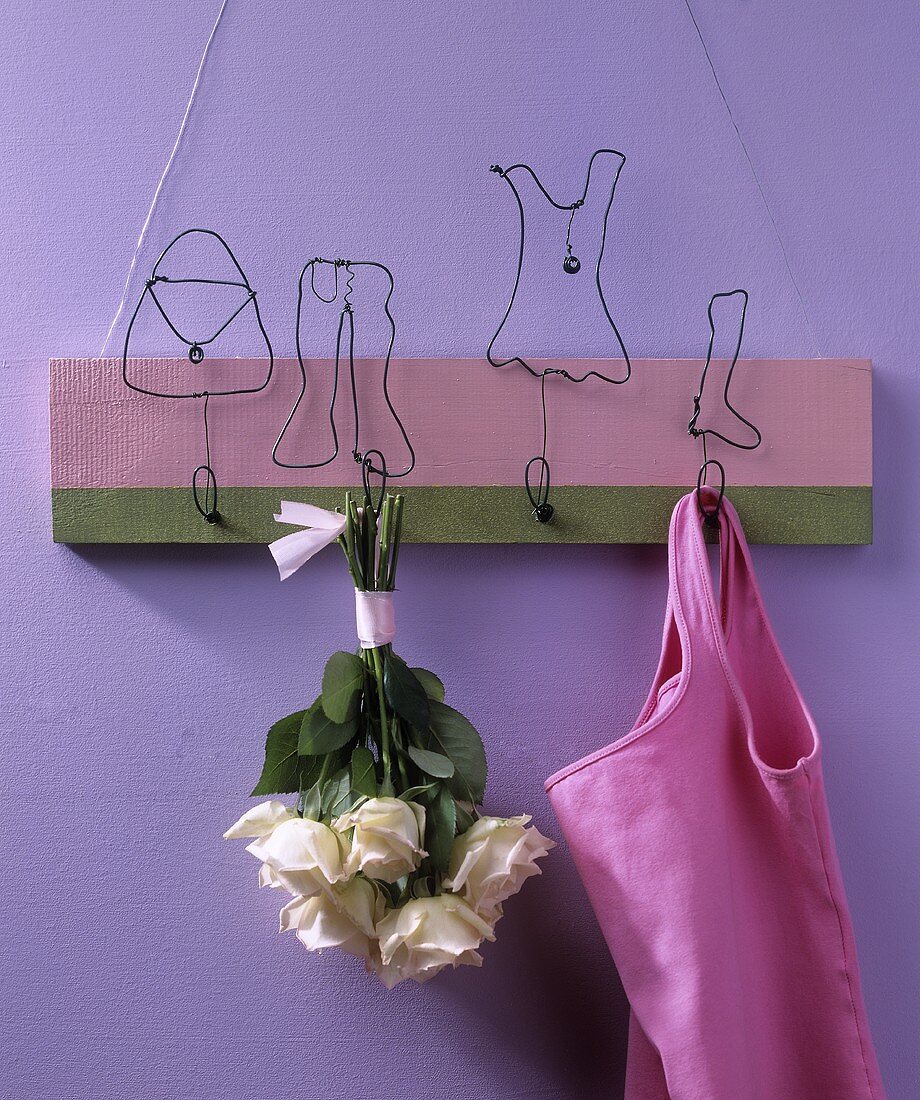 Wall-mounted coat rack with amusing wire figures