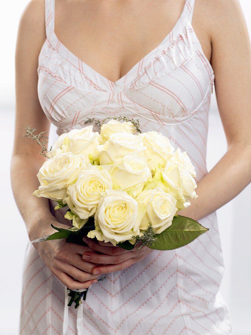 Woman with bouquet of white roses