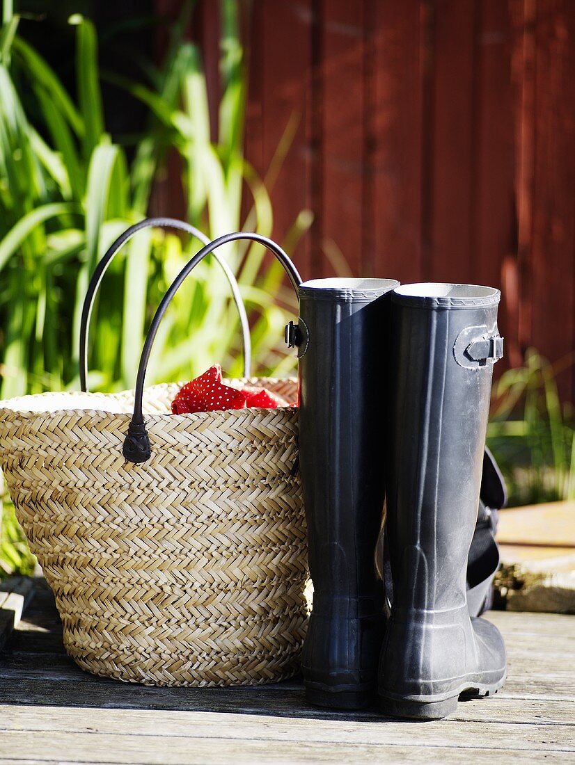 Wicker basket and a pair of galoshes