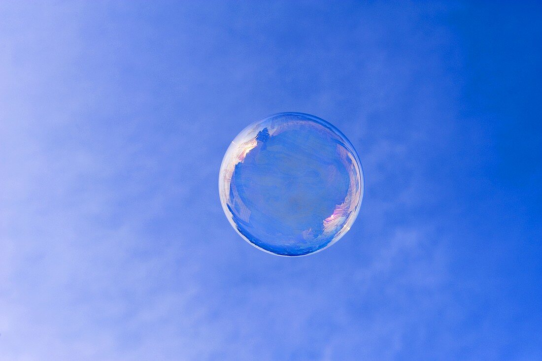 Soap bubble in front of a blue sky