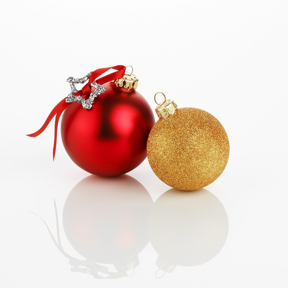 Two different Christmas baubles (red and gold)