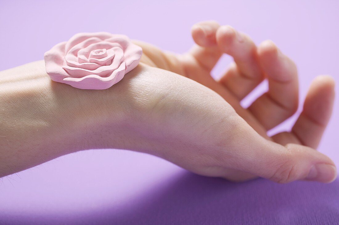 Rose soap on someone's hand