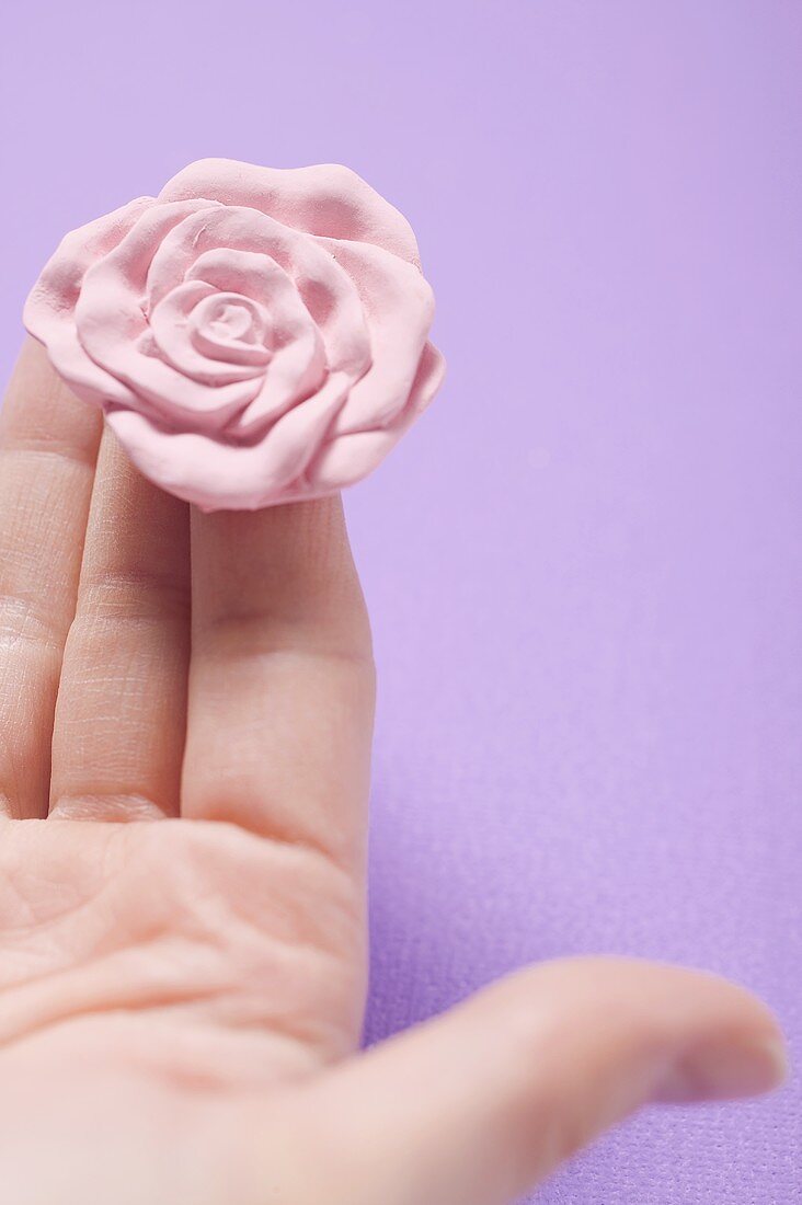 Rose soap on someone's fingers