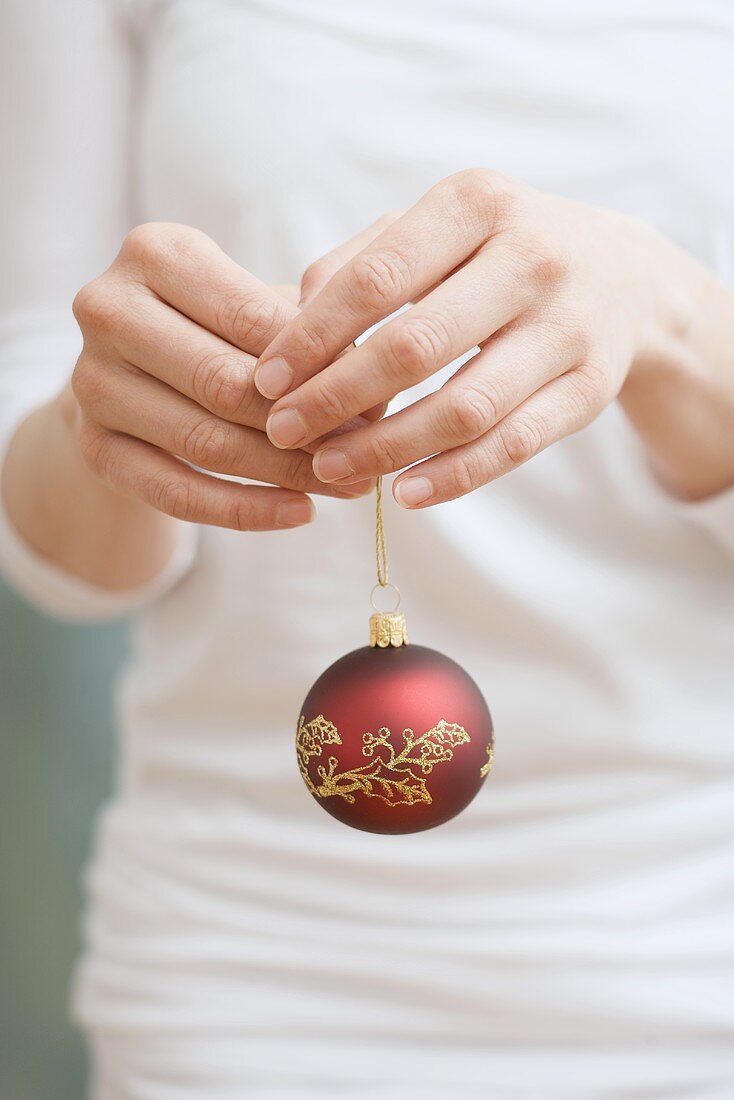 Woman holding Christmas bauble