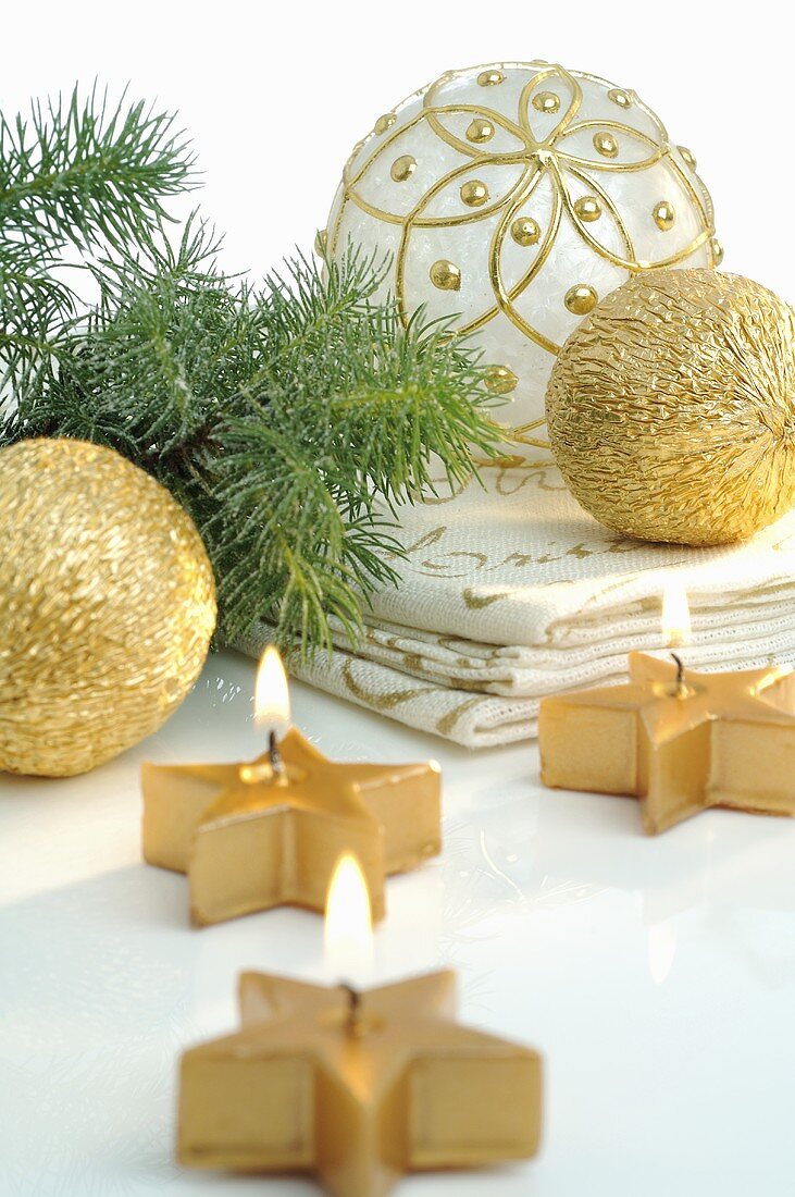 Gold candles and Christmas baubles