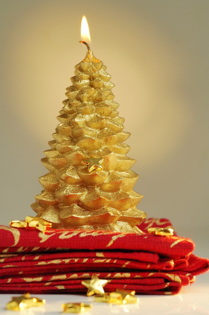 Gold Christmas candle on napkins