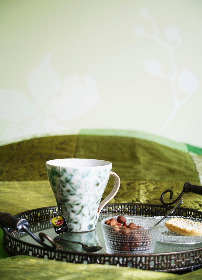 Breakfast tray on a bed with a green bedspread