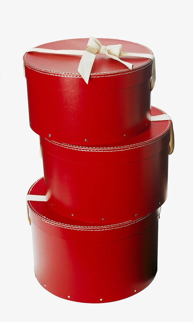 Three red hatboxes