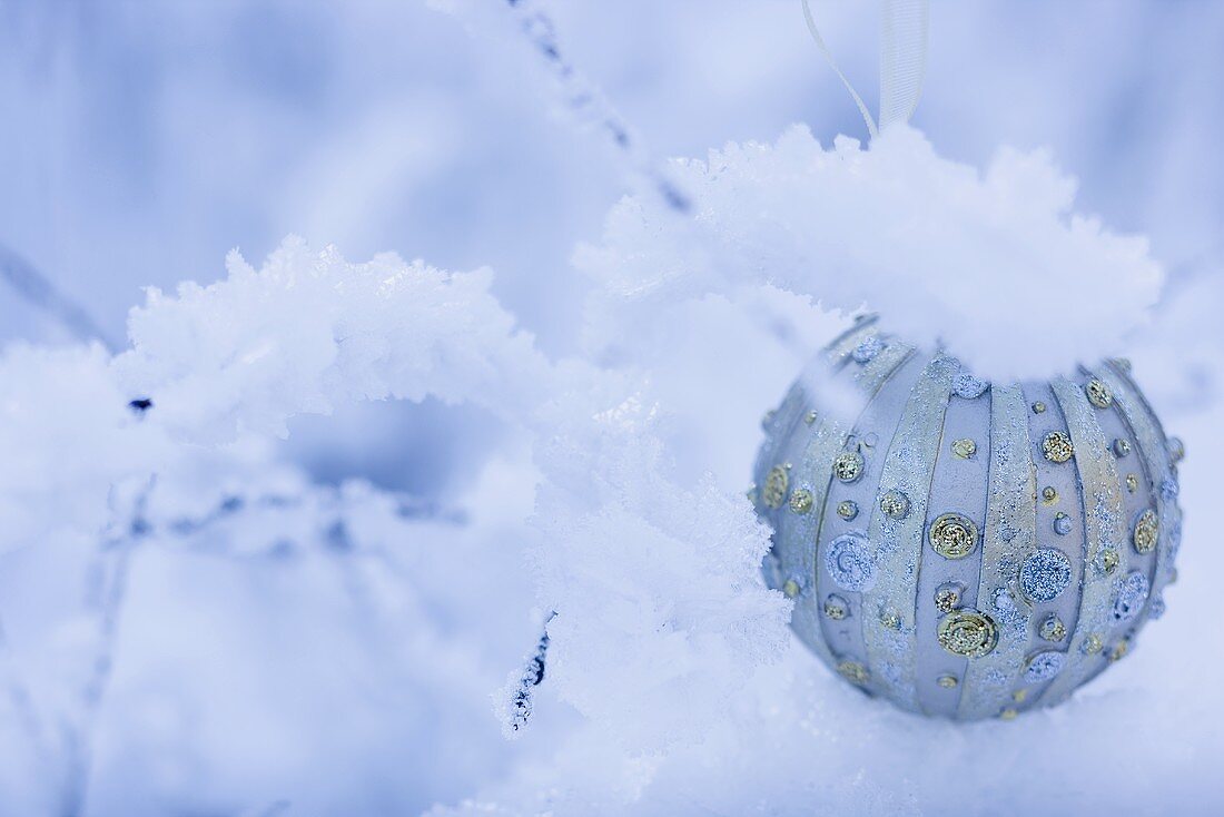 Christmas bauble in snow