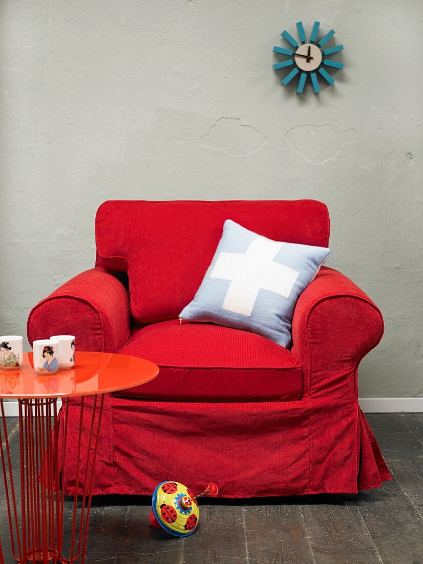 Red armchair with scatter cushion