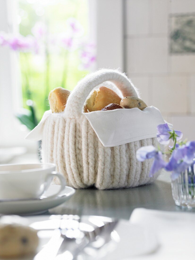 A white crocheted bread basket