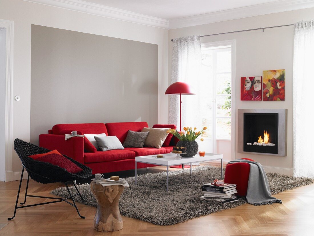 Living room in red and grey with sofa and fireplace