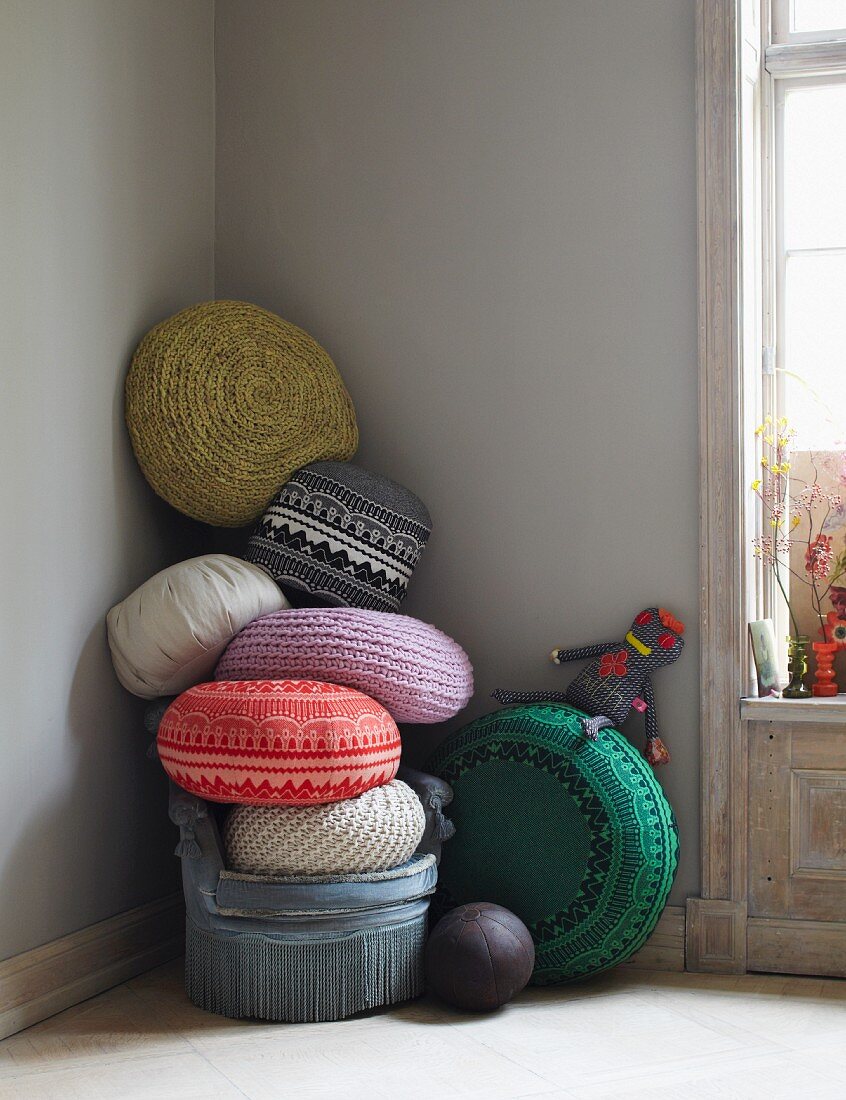 Various cushions stacked in a corner