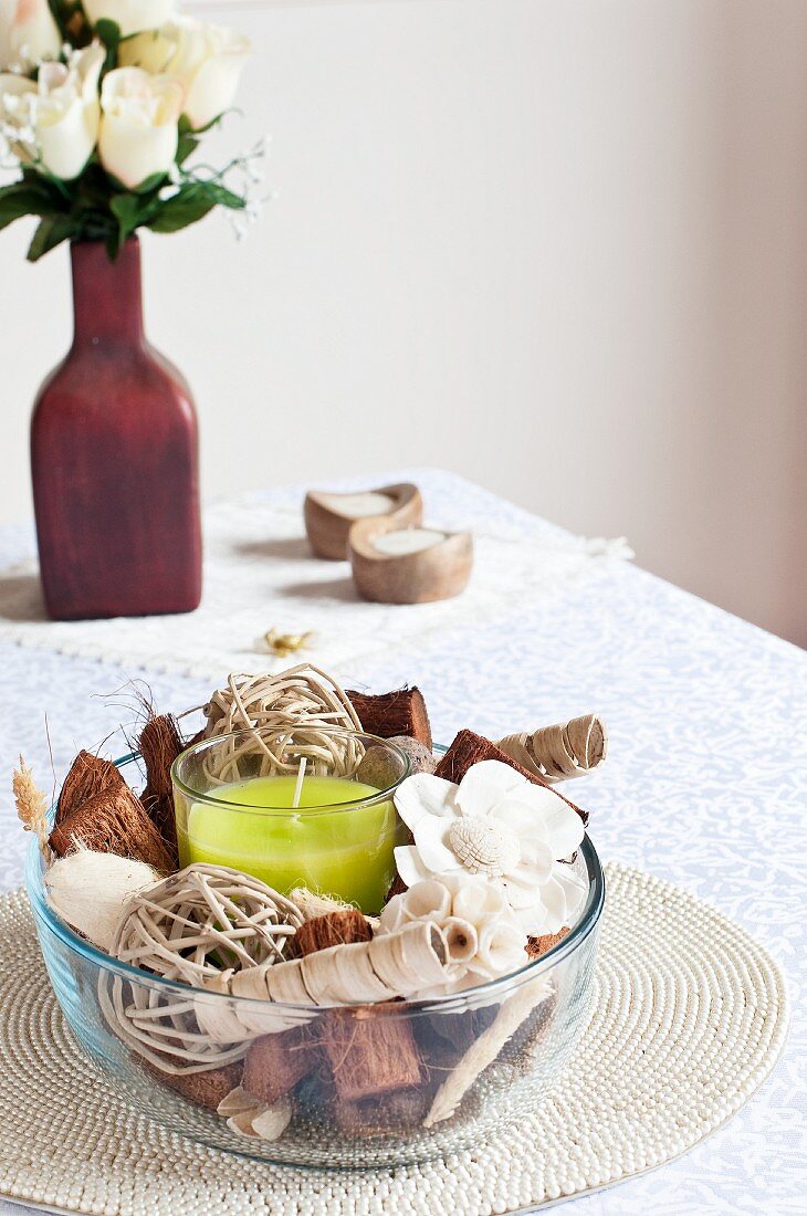 Candle and vanilla potpourri in glass bowl