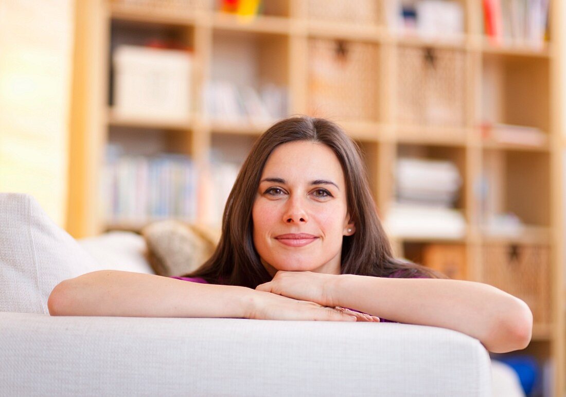 Smiling woman relaxing on sofa
