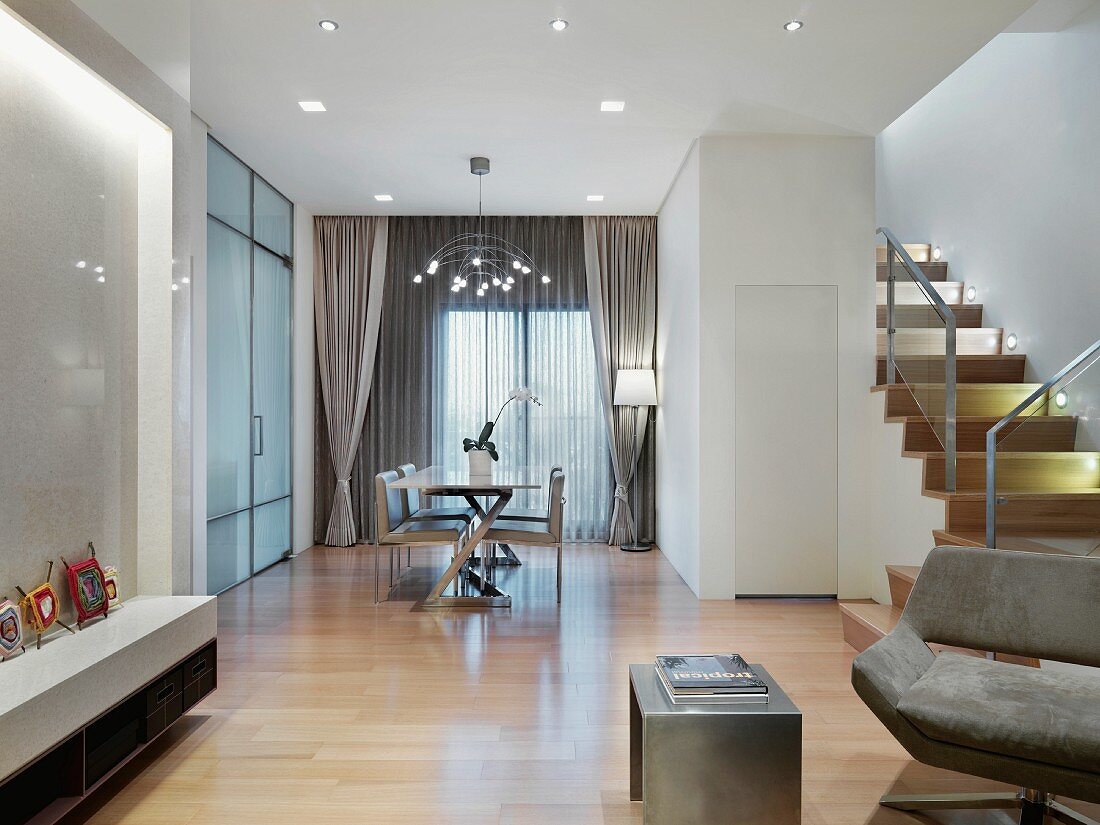 Modern living room with an eating area and open staircase