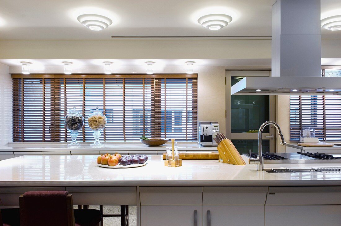 Kitchen counter with fruit bowls next to kitchen utensils with a modern feel
