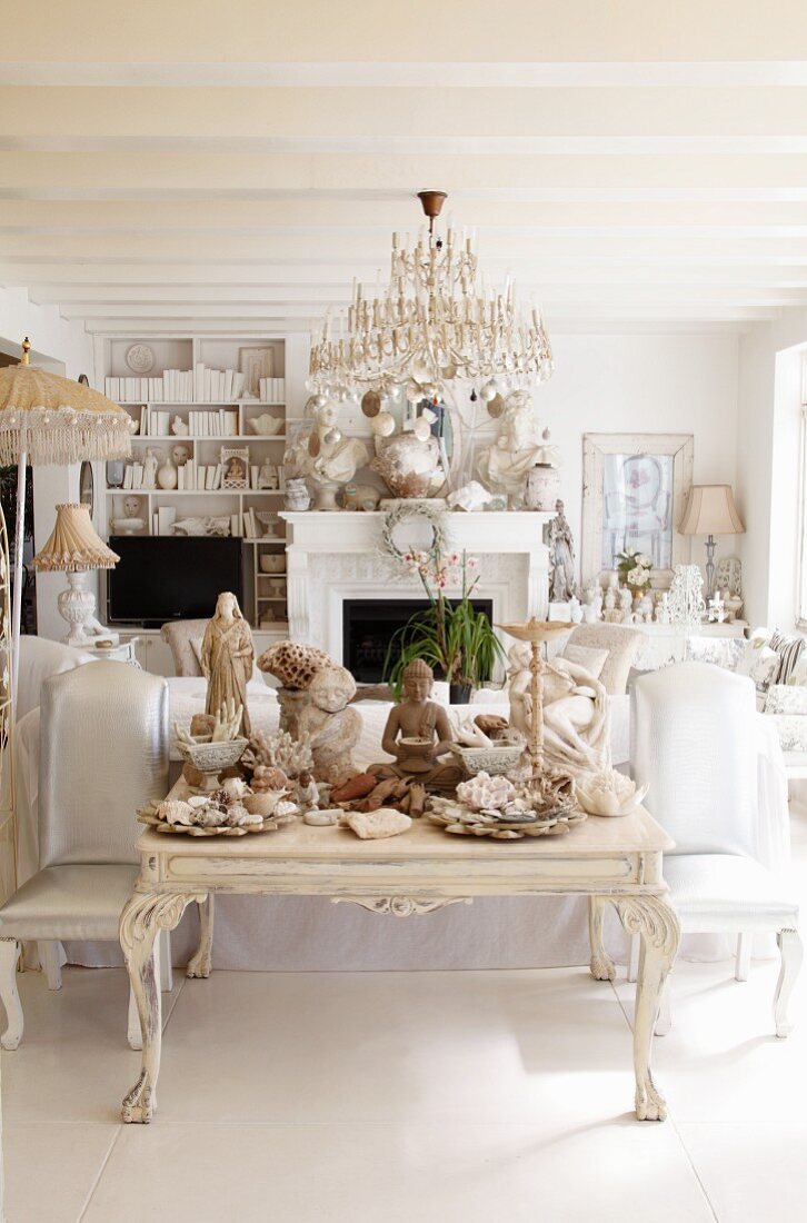 Eclectic collection of sculptures in white living room