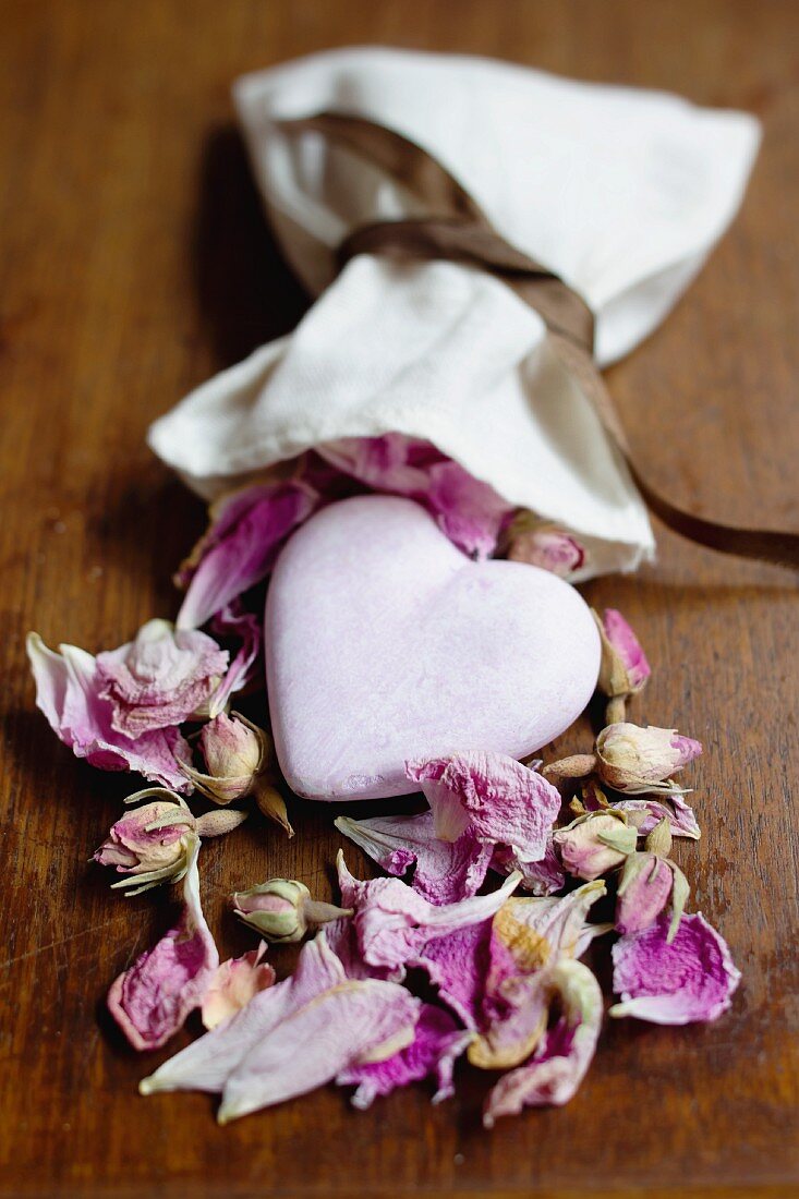 Heart lying in dried rose petals