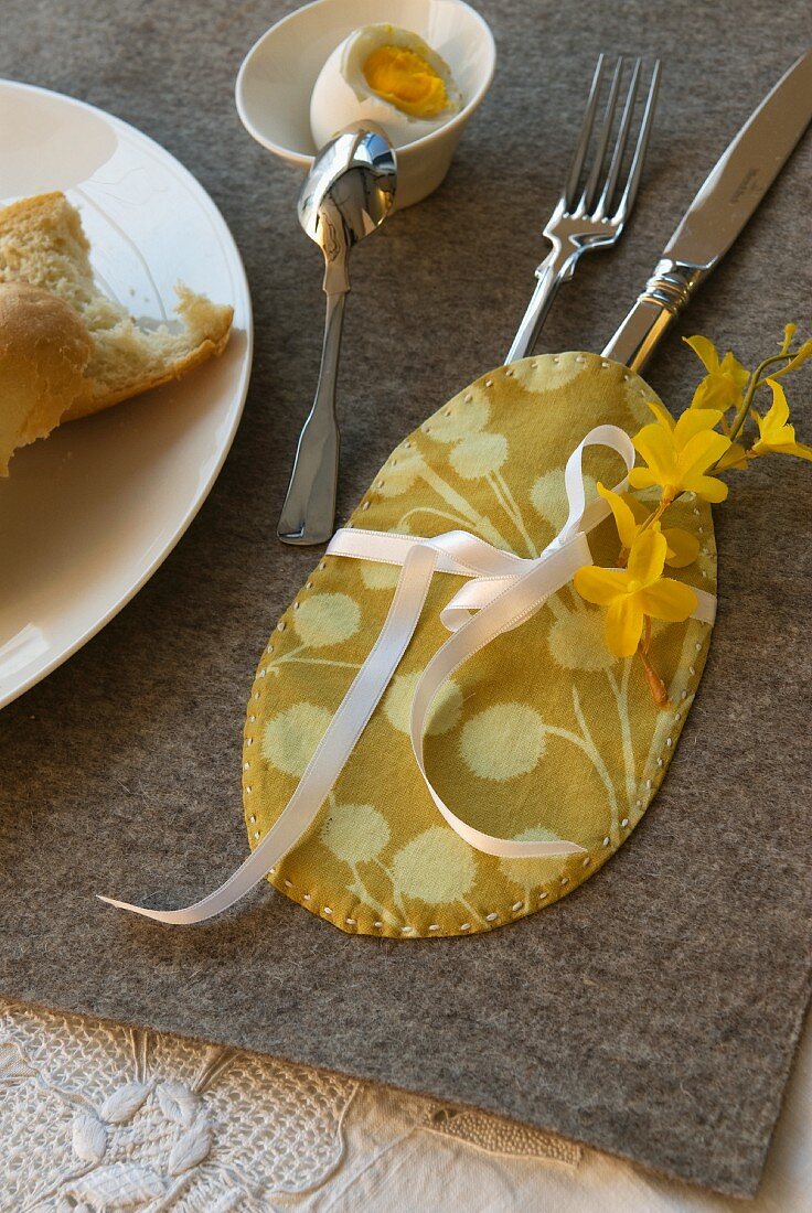 Egg shaped cutlery pouch decorated with forsythia
