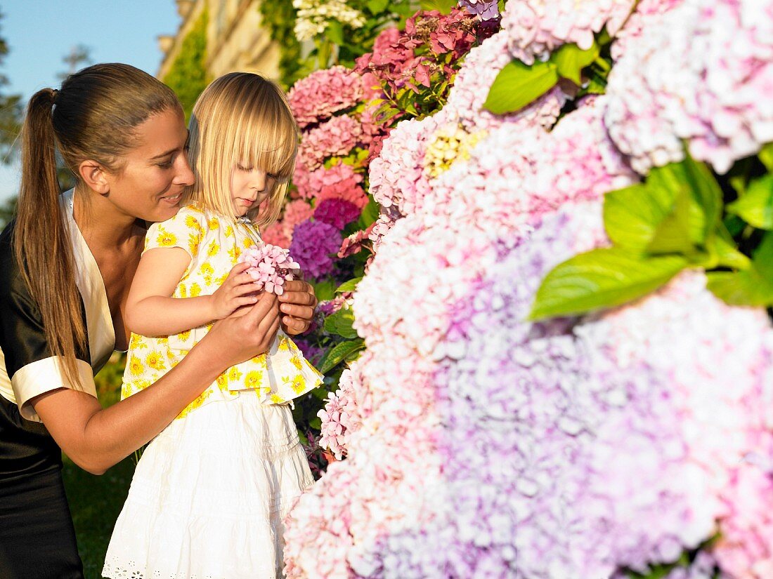 Woman and girl looking at flowers
