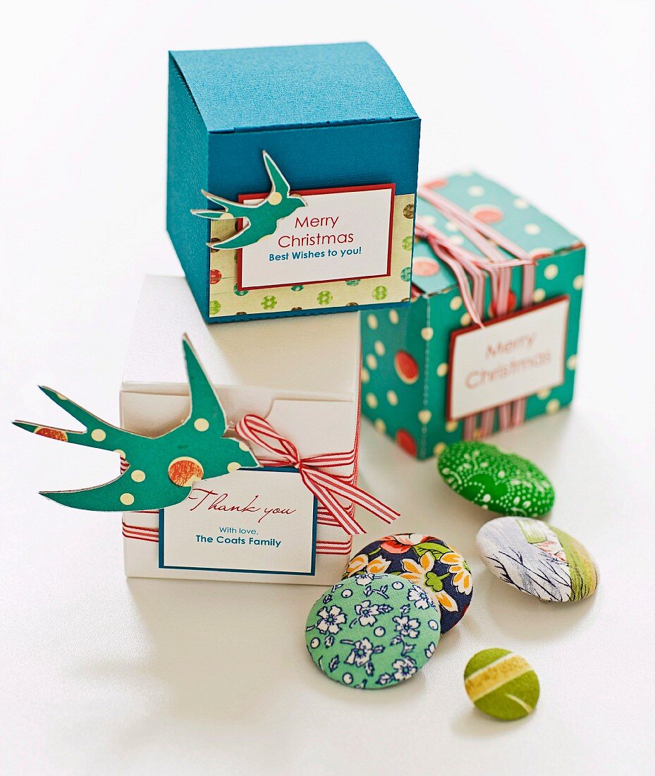 Various colourful buttons and cubic gift boxes with ribbons and labels