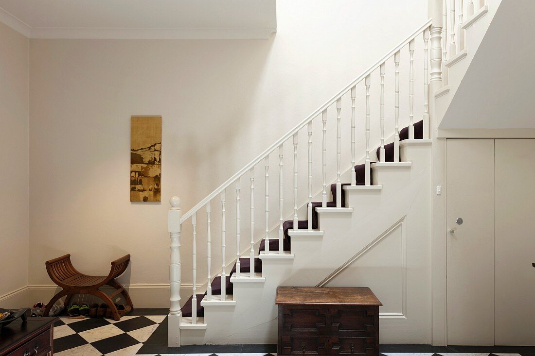 A classic stairway with turned banister and stair runner