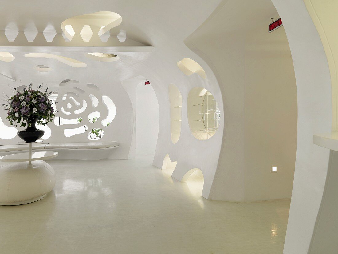 Futuristic, monochromatic white lobby with cutouts in wall