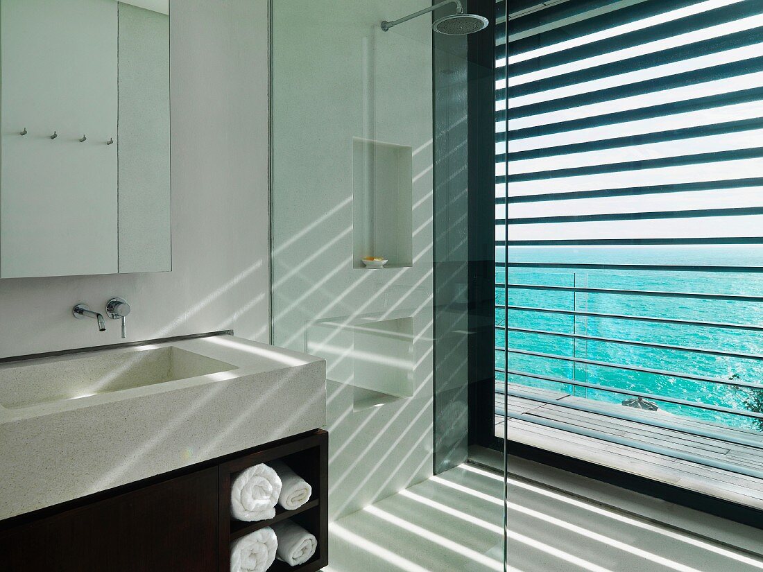 Sunlight streaming through blinds in modern bathroom
