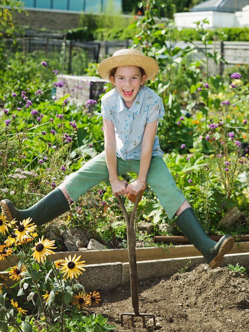 A young girl in a allotment garden