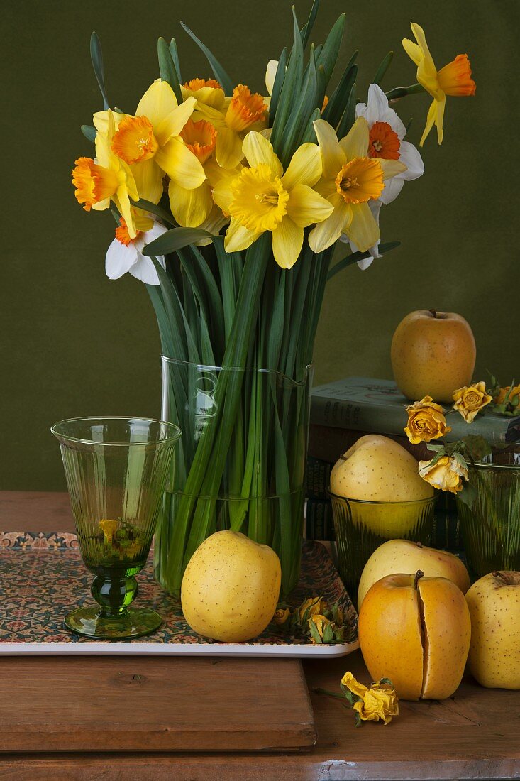 Vase of daffodils with Golden Delicious and Temptation apples