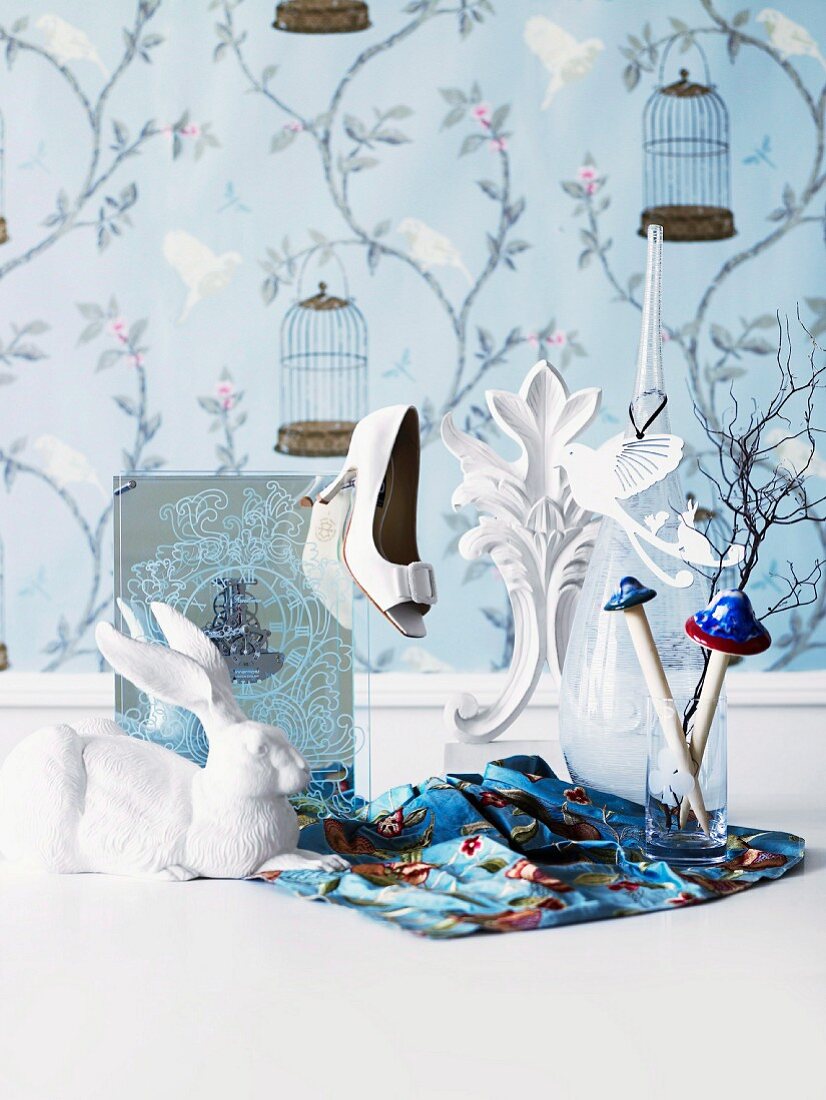 Playfuly decorated - a white rabbit and ladies shoe in front of floral and wallpaper with birds and flowers