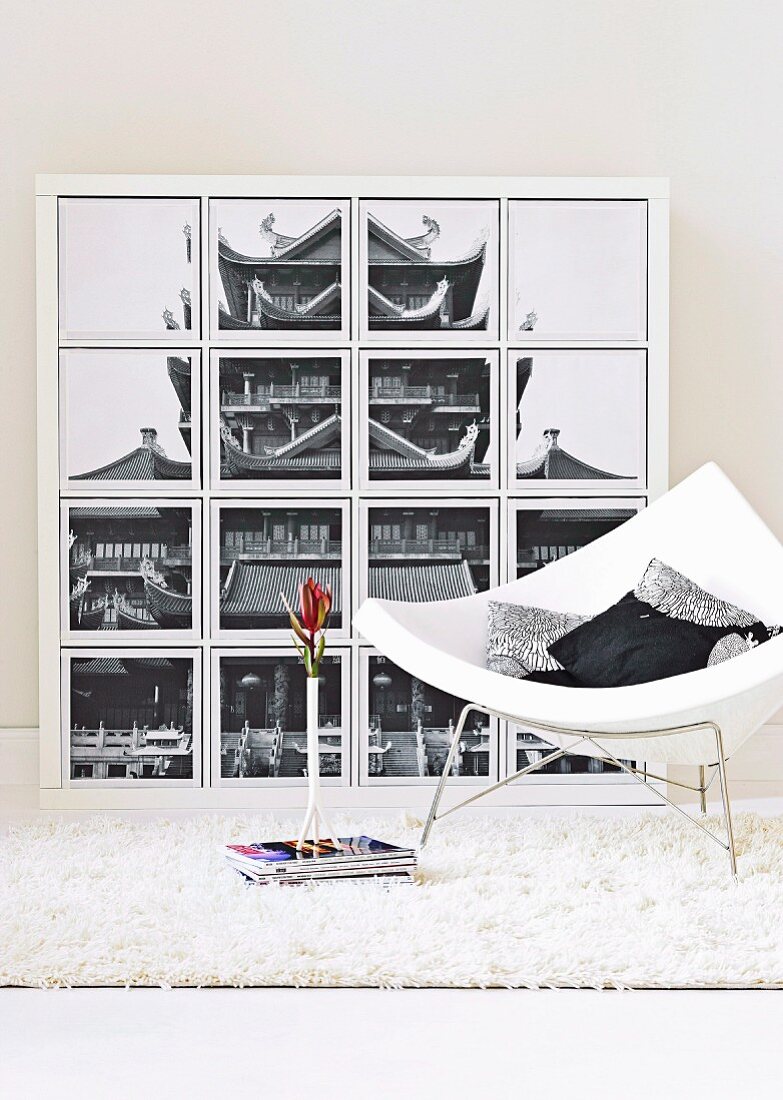 Designer armchair in front of artwork in panels