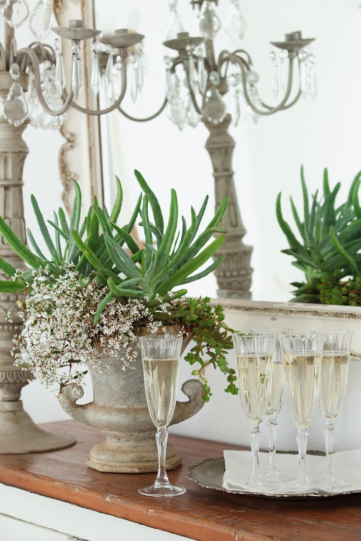 Champagne flutes, flower arrangement in amphora and candelabra