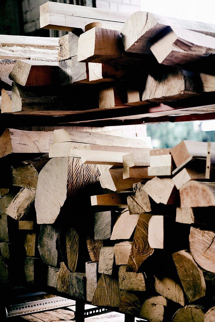 Large stack of wood on metal shelving
