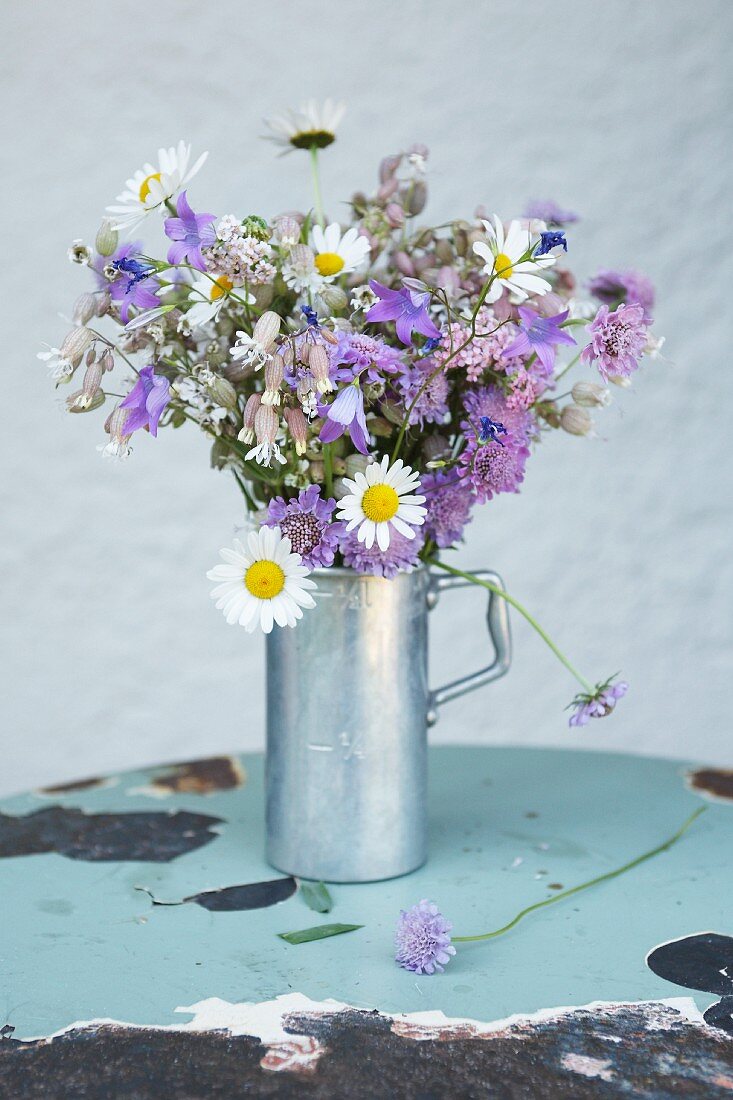 Bouquet made of daisies, purple bellflowers and wild flowers