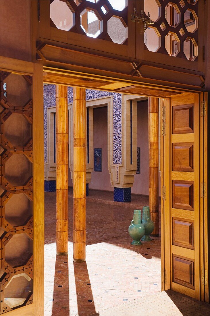 Blick durch Türöffnung mit Holzverkleidung in marokkanischen Innenhof
