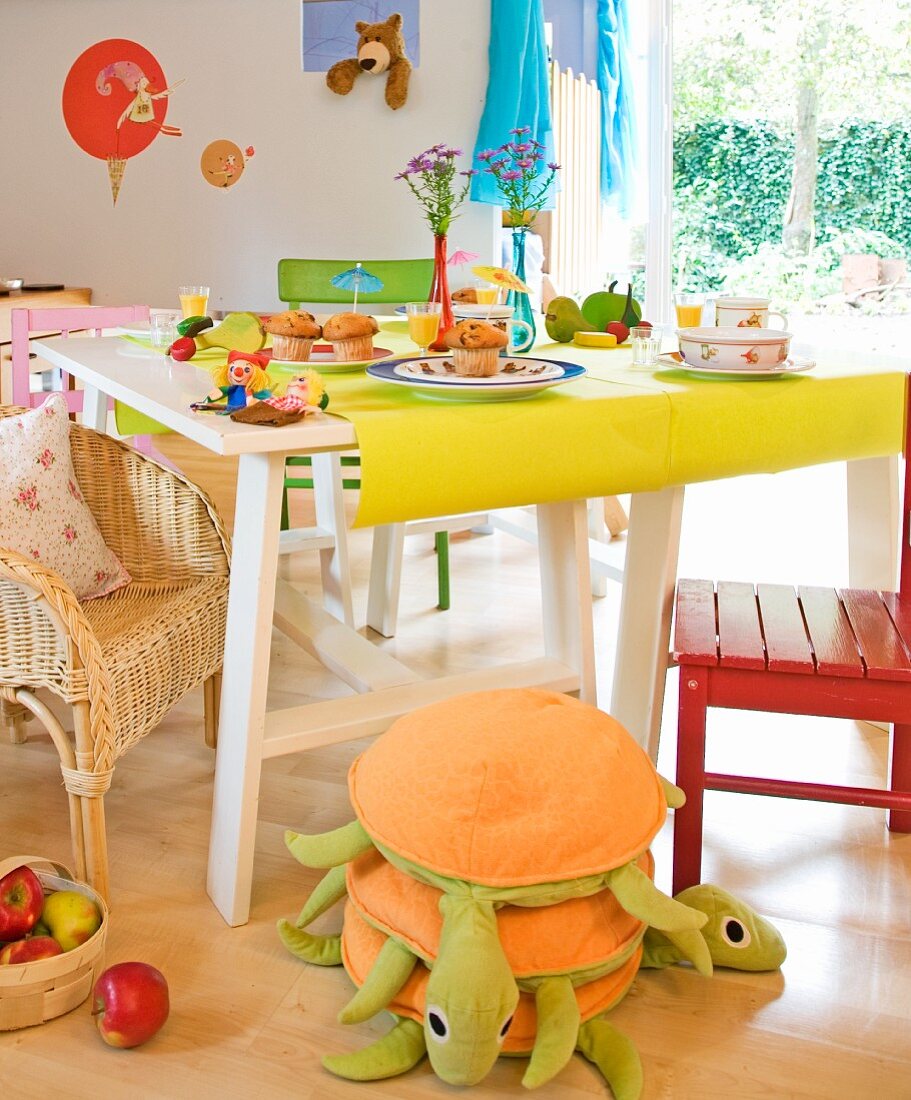 Dining table with muffins and orange juice in a playroom
