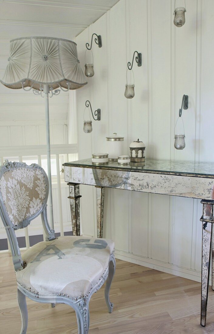 Mirrored console table and renovated antique chair on gallery
