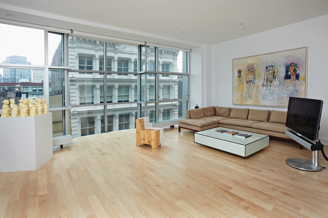 Living Room with a Wall of Windows with City Views