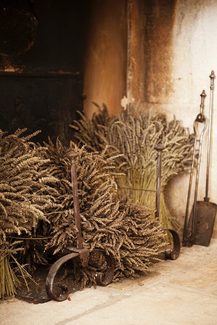 Dried lavender bunches in the grate of an old stone fireplace