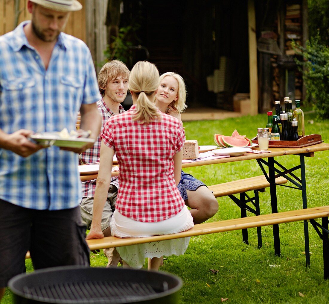 Friends enjoying a barbeque in the garden
