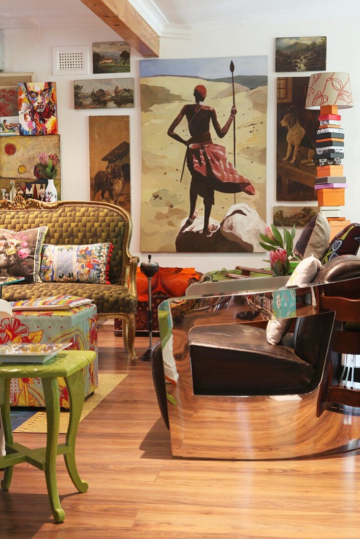 Colourful, eclectic mixture of furniture and paintings