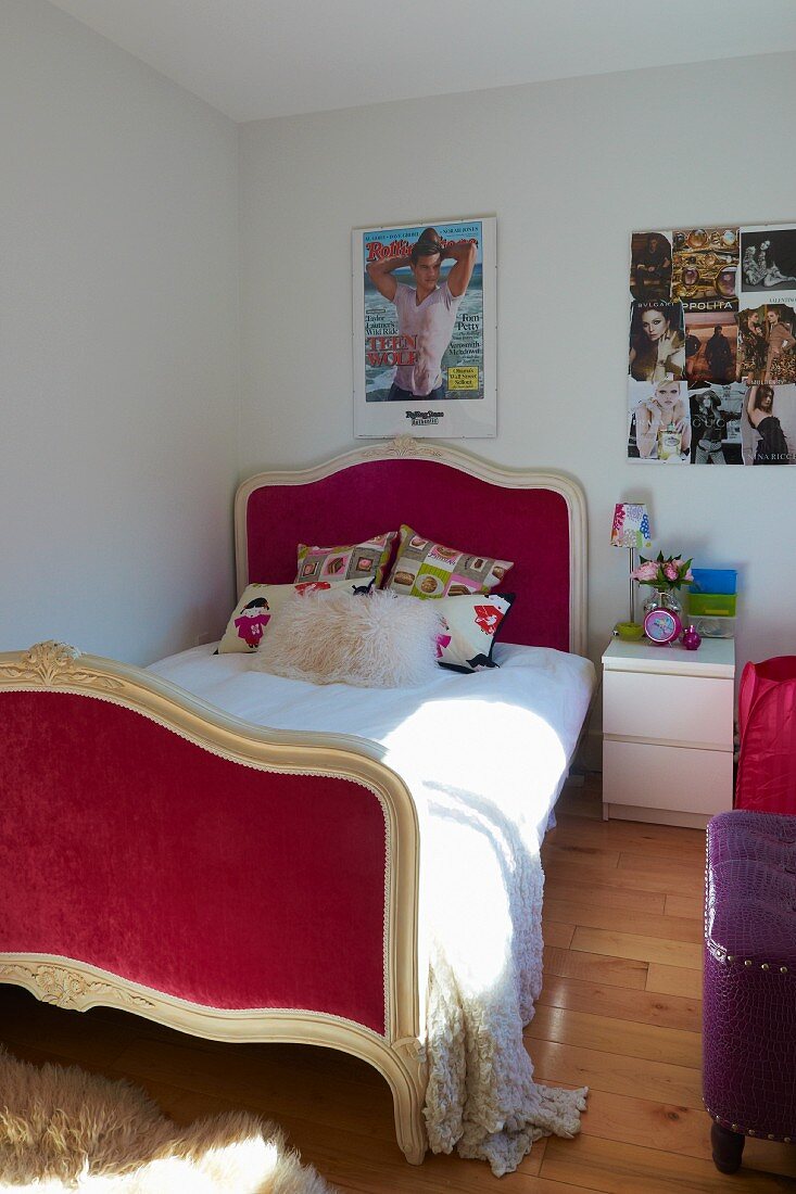 Mädchenzimmer mit romantischem, roten Bett; daneben ein modernes Nachtkästchen