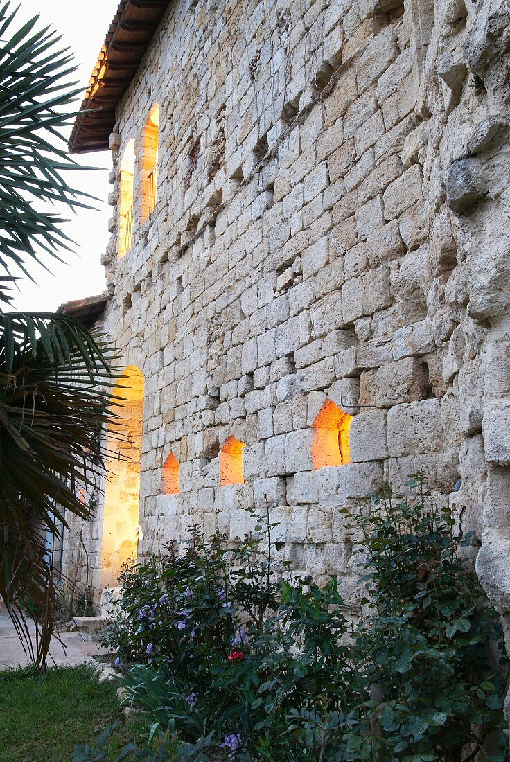 Illuminated window apertures in facade of Chateau Maignaut