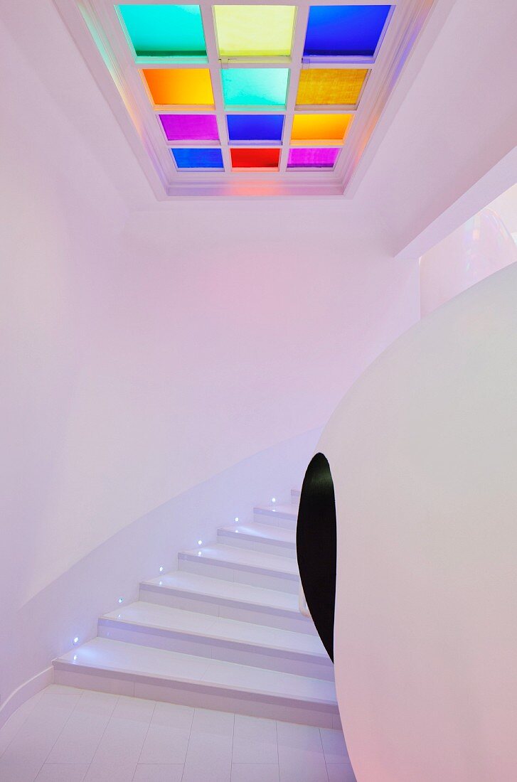 Spherical installation and square ceiling lamp with coloured glass elements in modern stairwell